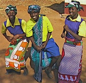Kenyans wearing dancing wearing Kangas